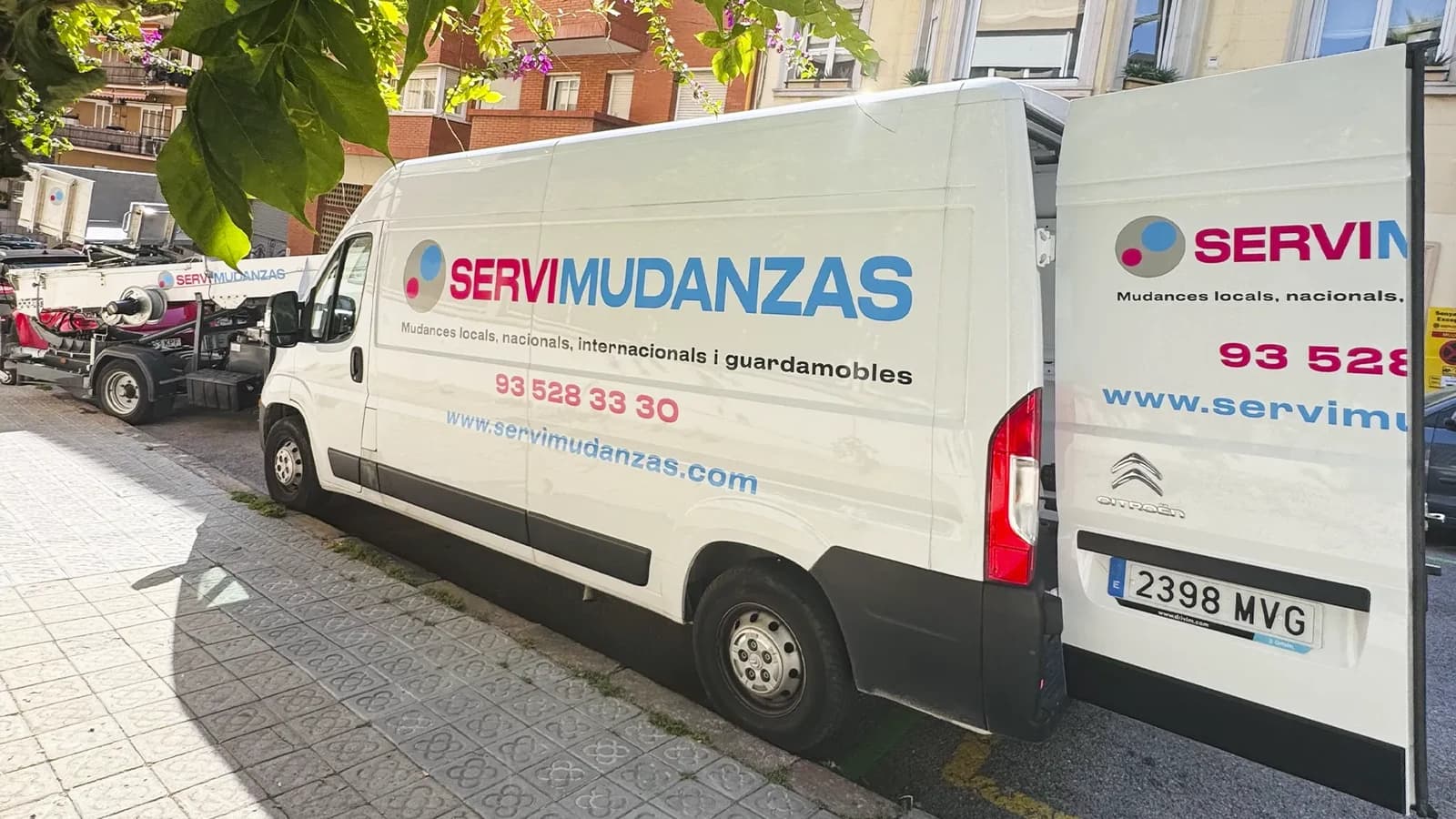 Flota de furgonetas de mudanza Servimudanzas aparcadas en calle de Barcelona